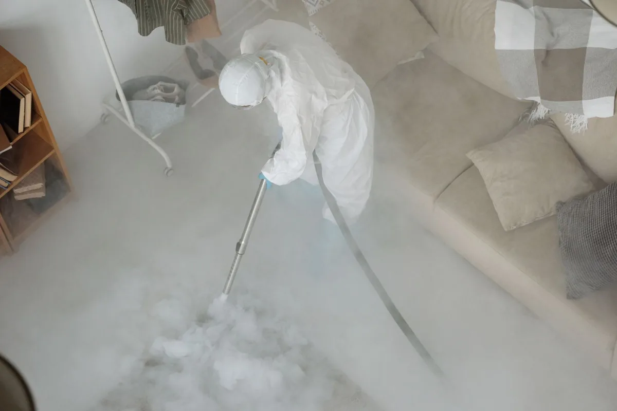 Biohazard cleanup technician in protective equipment, Wellington, CO
